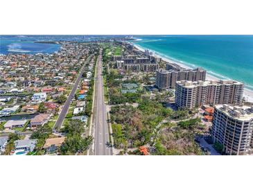 Spectacular aerial view showcasing beachfront condos and the beautiful coastline of the property at 1241 Gulf Of Mexico Dr # 603, Longboat Key, FL 34228