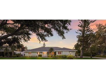 Charming single-story home with lush landscaping, mature trees, and a well-manicured lawn at 1411 70Th Nw St, Bradenton, FL 34209