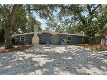 Charming single-story home features a large front yard and eye-catching blue exterior door at 2848 Trinidad St, Sarasota, FL 34231