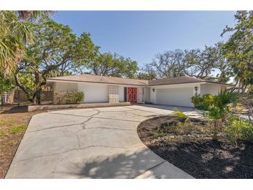 Attractive home featuring a two-car garage, eye catching front doors, and a neatly landscaped yard at 717 Treasure Boat Way, Sarasota, FL 34242