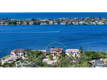 A panoramic aerial view of a waterfront property with lush landscaping and serene blue water views at 7342 Captain Kidd Ave, Sarasota, FL 34231