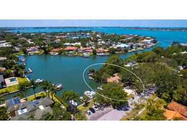 Waterfront property on lush peninsula with boat dock and bay access surrounded by manicured landscaping at 1542 Gulfview Dr, Sarasota, FL 34236