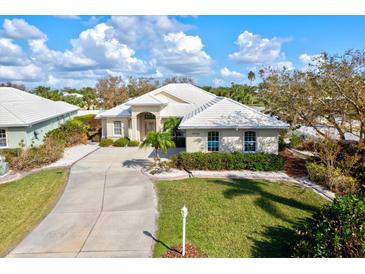 Attractive single-Gathering home boasts a tile roof, large driveway, and neatly manicured lawn in a bright setting at 22324 Wexford Blvd, Venice, FL 34293