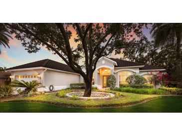 Charming home featuring lush landscaping, mature trees, and a well-maintained lawn at 2309 Chardonnay Ter, Parrish, FL 34219