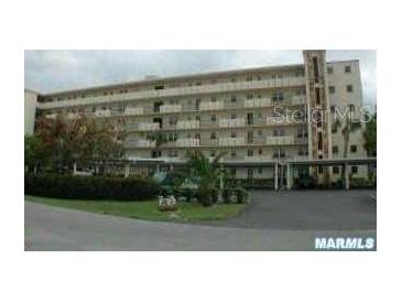 Condominium building featuring multiple stories and well-maintained landscaping at 3620 Ironwood Cir # 506-O, Bradenton, FL 34209