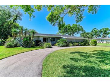 Charming single-story home featuring a well-manicured lawn and a circular driveway at 4611 17Th W Ave, Bradenton, FL 34209