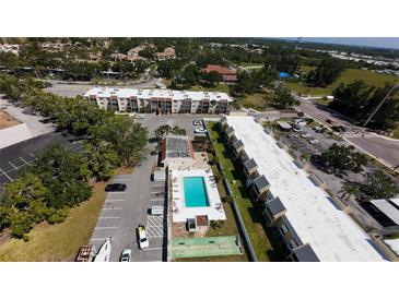 A picturesque aerial view of the condo complex shows the refreshing community pool at 519 Albee Farm Rd # 201, Venice, FL 34285