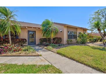 Charming home with mature landscaping, including palm trees and colorful shrubbery, creating curb appeal at 6209 Heritage Ln # 6209, Bradenton, FL 34209