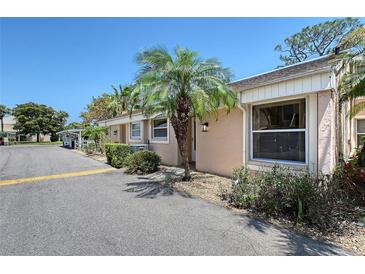 Charming exterior of a home featuring a well-maintained lawn and attractive landscaping, with a clear blue sky overhead at 6240 7Th W Ave # 6240, Bradenton, FL 34209