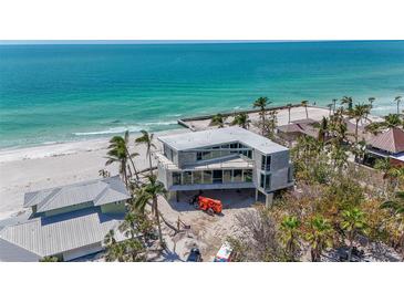 Modern beach house showcasing ocean views and contemporary design with floor to ceiling windows at 6603 Gulfside Rd, Longboat Key, FL 34228