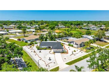 Charming home boasts a well-maintained yard with beautiful landscaping, enhancing its curb appeal at 6628 Keystone Dr, Sarasota, FL 34231