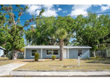 Charming single-story home features a well-maintained front yard with mature trees and a cozy entrance at 1823 8Th E Ave, Bradenton, FL 34208