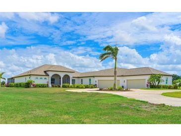 Wide front lawn showcasing a single story home, circular driveway and three car garage at 6316 Foxbrook Trl, Parrish, FL 34219