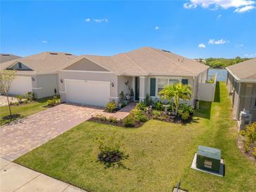Beautiful single story home with a well maintained lawn, landscaping, and a brick driveway at 7322 34Th E Ct, Sarasota, FL 34243