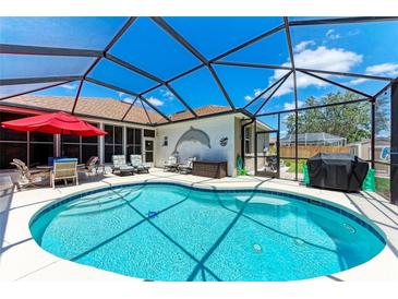 Sparkling pool with screened-in enclosure, surrounded by outdoor seating and lush landscaping at 7814 48Th E Ave, Bradenton, FL 34203
