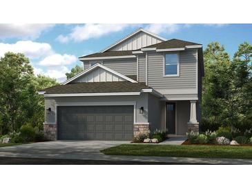 Charming two-story home with a two-car garage, stone accents, and well-manicured landscaping at 8505 Snowfall St, Sarasota, FL 34241