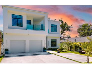 Modern two-story home featuring an attached two-car garage, balcony and minimalist landscaping at 1842 Kenilworth St, Sarasota, FL 34231