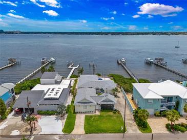 Stunning aerial view of waterfront homes with private docks on a sunny day with lush landscaping at 1907 4Th W St, Palmetto, FL 34221