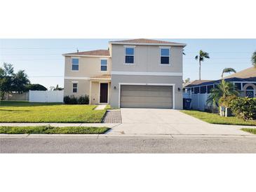 Two-story home showcasing a well-maintained lawn and a convenient two-car garage at 215 63Rd E Dr, Bradenton, FL 34203