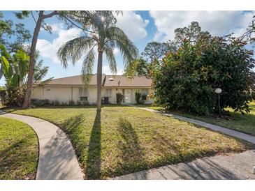 Charming single-story home featuring a well-manicured lawn, mature landscaping, and a welcoming front entrance at 5382 Royal Palm Ave # 5382, Sarasota, FL 34234