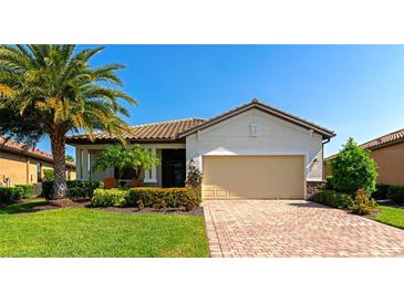 Beautiful single-story home with lush landscaping, brick driveway, and a two-car garage at 6524 Willowshire Way, Bradenton, FL 34212