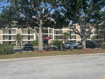 Beautiful apartment complex with mature landscaping and covered parking at 7461 W Country Club N Dr # 201, Sarasota, FL 34243