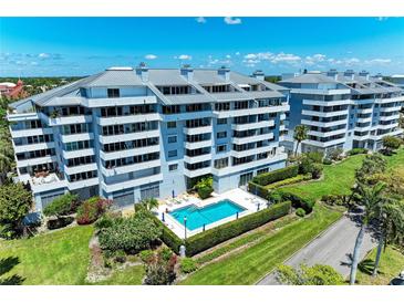 Modern condominiums featuring a sparkling pool, well maintained landscaping, and balconies with views at 1000 Riverside Dr # B202, Palmetto, FL 34221