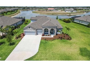 Beautiful single-Gathering home featuring a well-manicured lawn, neutral paint colors, and an attached two-car garage at 14914 15Th E St, Parrish, FL 34219
