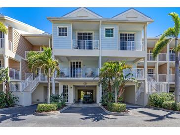 Attractive three-story townhouse with balconies and tropical landscaping at 3248 Mangrove Point Dr, Ruskin, FL 33570