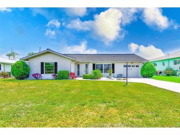 Charming single-story home with well-manicured lawn, lush landscaping, and a clean, inviting exterior at 4908 Commonwealth Rd, Palmetto, FL 34221