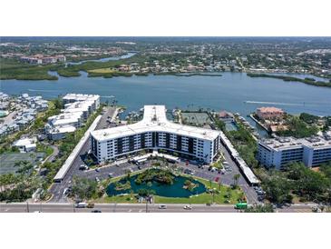Stunning aerial view of condo community with bay access and waterfront views at 5855 Midnight Pass Rd # 512, Sarasota, FL 34242