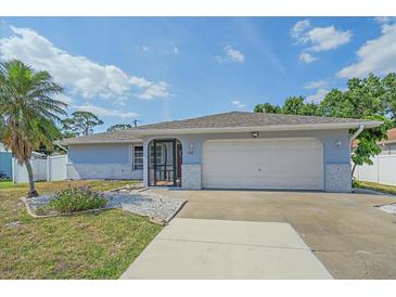 Charming single-story home featuring an attached two-car garage, well-maintained lawn, and mature palm tree at 108 Stanford Rd, Venice, FL 34293