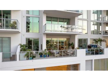 Relaxing balcony with sleek glass railings and stylish furniture, perfect for enjoying outdoor living at 301 Quay Commons # 503, Sarasota, FL 34236
