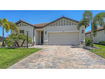 Charming single-story home features a two-car garage, tiled roof, and well-manicured landscaping at 3803 Savanna Palms Ct, Bradenton, FL 34211