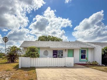 Charming single-story home featuring a bright turquoise door and well-maintained, white picket fence at 3909 40Th W St, Bradenton, FL 34205