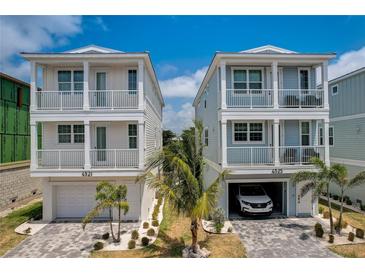 Stunning exterior showcasing modern architecture with a paver driveway and beautiful landscaping at 4206 Saltwater Pearl Way, Cortez, FL 34215