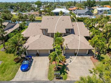 Expansive home with a three-car garage, lush landscaping, and waterfront views, all enhanced by a private dock at 6780 Schooner Bay Cir # 6780, Sarasota, FL 34231
