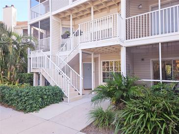 Charming condo with inviting stairwell, complemented by lush landscaping and neutral tones at 850 S Tamiami Trl # 704, Sarasota, FL 34236