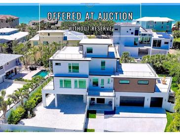 Stunning three-story home with a rooftop deck and modern architectural design, located near a beautiful beach at 8800 Midnight Pass Rd, Sarasota, FL 34242