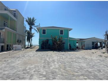 Turquoise two-story home near the beach with a brick parking area at 1190 Shore View Dr # C, Englewood, FL 34223