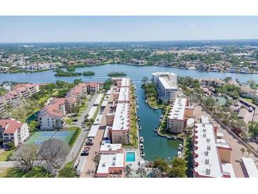 Beautiful aerial view of a waterfront condo community with boat docks and picturesque bay views at 1250 N Portofino Dr # 304, Sarasota, FL 34242