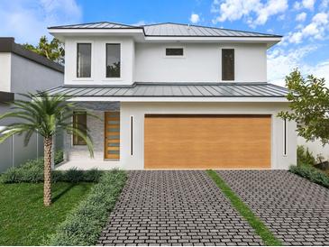Modern two-story home features a stylish garage, sleek driveway, and well-maintained landscaping at 2483 Bay St, Sarasota, FL 34237