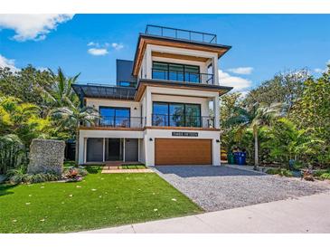 Stunning three-story modern home with a roof top terrace, sleek lines and lush landscaping at 315 N Bay Blvd, Anna Maria, FL 34216