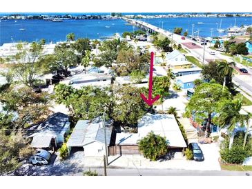 Charming waterfront cottage with mature trees, offering convenient access to the bridge and a serene coastal living experience at 4408 125Th W St, Cortez, FL 34215