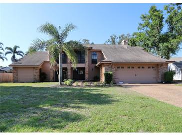 Charming two-story home with a well-manicured lawn, mature landscaping, and a spacious driveway at 5340 Dominica Cir, Sarasota, FL 34233