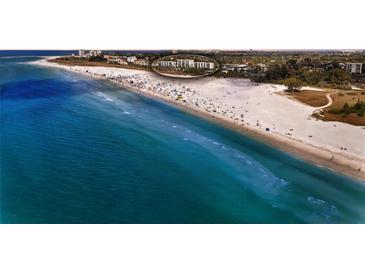 Beautiful beach view with clear blue water and white sand near the building at 777 Beach Rd # 1B, Sarasota, FL 34242