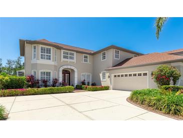 Elegant two-story home with a well-manicured lawn, beautiful landscaping, and a spacious three-car garage at 9226 13Th Avenue Nw Cir, Bradenton, FL 34209