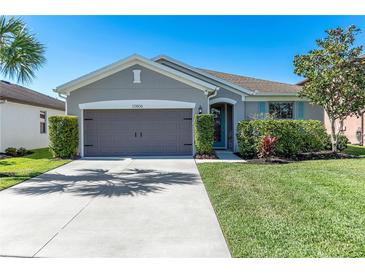Charming single-story home with a well-manicured lawn and attached two-car garage at 10806 52Nd E Ct, Parrish, FL 34219