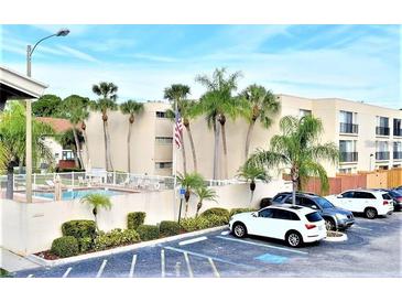 Relaxing condo community featuring a pool, palm trees and convenient parking at 2763 Woodgate Ln # 108, Sarasota, FL 34231
