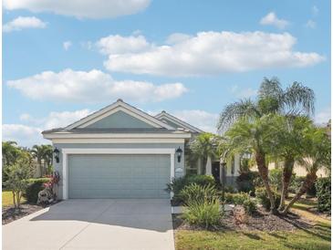 Charming single-story home featuring a well-manicured front yard and an attached two-car garage at 12676 Sagewood Dr, Venice, FL 34293